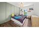This cozy bedroom features trendy decor and plenty of natural light from a window and fun light fixture at 3640 Pollys Blf, Cumming, GA 30028