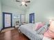 Bedroom featuring hardwood floors, light blue paint and a light-filled atmosphere at 3640 Pollys Blf, Cumming, GA 30028