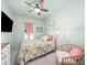 Cozy bedroom with a floral bedspread, chair, and complementary decor at 3640 Pollys Blf, Cumming, GA 30028