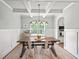 Dining room featuring a coffered ceiling, wainscoting, and a large window at 3640 Pollys Blf, Cumming, GA 30028