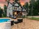 Charming home with a stone facade, outdoor seating, and a pool area perfect for entertaining at 3640 Pollys Blf, Cumming, GA 30028