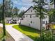 Beautiful home exterior featuring a well-maintained lawn, long driveway, and inviting outdoor deck and basement at 3640 Pollys Blf, Cumming, GA 30028