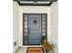 Close-up of a charming blue front door with sidelights and transom window at 3640 Pollys Blf, Cumming, GA 30028
