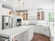 Modern kitchen with white cabinets, stainless steel appliances, and granite countertops at 3640 Pollys Blf, Cumming, GA 30028