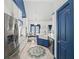 Well-equipped kitchen with stainless steel appliances and blue accents, leading to dining area at 3640 Pollys Blf, Cumming, GA 30028