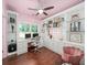 Bright home office with built-in shelving and a window overlooking the yard at 3640 Pollys Blf, Cumming, GA 30028