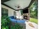 Inviting covered patio with an outdoor fireplace, comfortable seating, and a relaxing atmosphere for entertaining and unwinding at 3640 Pollys Blf, Cumming, GA 30028