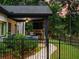 Cozy outdoor living space with a stone fireplace, tv, and fenced yard for added privacy at 3640 Pollys Blf, Cumming, GA 30028