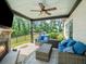 Covered outdoor patio with stone fireplace, comfortable seating, and views of the fenced backyard with a sparkling pool at 3640 Pollys Blf, Cumming, GA 30028