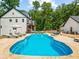 Backyard pool on property with white home, basketball court and seating at 3640 Pollys Blf, Cumming, GA 30028