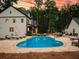 Stunning backyard pool with a large patio, ample seating, and a view of the beautifully designed home at 3640 Pollys Blf, Cumming, GA 30028