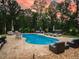 Stunning backyard with a large swimming pool, patio furniture, and mature trees, creating a perfect outdoor oasis at 3640 Pollys Blf, Cumming, GA 30028