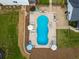 Aerial view of the kidney bean-shaped pool featuring ample seating, umbrellas, and a tanning deck at 3640 Pollys Blf, Cumming, GA 30028