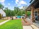 Tranquil porch view showcases the pool and manicured lawn, stone columns, and peaceful outdoor living at 3640 Pollys Blf, Cumming, GA 30028