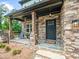 Charming front porch featuring stone columns, flagstone flooring, and comfortable seating, creating an inviting entry at 3640 Pollys Blf, Cumming, GA 30028