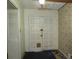 View of the home's entryway featuring double doors, floral wallpaper, and tile flooring at 5114 Fawn Se Trl, Mableton, GA 30126