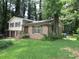 Two-story brick and siding home with front lawn and mature trees at 5114 Fawn Se Trl, Mableton, GA 30126