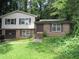Two-story home with brick and siding, attached garage, and front yard at 5114 Fawn Se Trl, Mableton, GA 30126