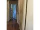 Hallway with hardwood floors leading to an open doorway at 5114 Fawn Se Trl, Mableton, GA 30126
