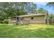 A view of the back of the house with siding, back deck, screened porch, and grassy backyard at 96 S Forty Pass S, Hiram, GA 30141