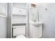 Small bathroom featuring toilet, sink and vanity with storage, and a large built-in shelving unit at 96 S Forty Pass S, Hiram, GA 30141