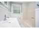 Tidy bathroom featuring a white vanity with chrome faucet and a tub/shower with white tile surround at 96 S Forty Pass S, Hiram, GA 30141