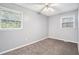 Clean bedroom with neutral colored walls, plush carpeting, ceiling fan, and good natural light from two windows at 96 S Forty Pass S, Hiram, GA 30141
