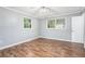 Light filled bedroom with natural light from two windows, hardwood floors, and simple decor at 96 S Forty Pass S, Hiram, GA 30141