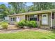 Cozy home featuring mature landscaping, complemented by a well-maintained green lawn at 96 S Forty Pass S, Hiram, GA 30141
