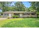 Single-story home featuring a well-kept lawn, complemented by mature trees and landscaping at 96 S Forty Pass S, Hiram, GA 30141