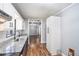 Bright kitchen features granite countertops, stainless steel sink and faucet, plus white cabinets and hardwood floors at 96 S Forty Pass S, Hiram, GA 30141