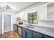 Stylish kitchen featuring granite countertops, stainless steel appliances, and blue cabinets at 96 S Forty Pass S, Hiram, GA 30141