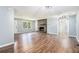 Bright and airy living room featuring hardwood floors, a brick fireplace, and ample natural light at 96 S Forty Pass S, Hiram, GA 30141