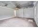 Open living area with unique ceiling design, carpet flooring, and a painted brick column divider at 96 S Forty Pass S, Hiram, GA 30141
