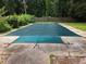 A view of the in-ground swimming pool with a safety cover over it at 96 S Forty Pass S, Hiram, GA 30141
