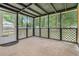 A view of the screened-in back porch, enclosed with lattice work and a door to the grassy backyard at 96 S Forty Pass S, Hiram, GA 30141