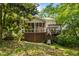 Spacious backyard features a screened porch, deck, pond, and mature trees for privacy at 1788 River Bluff Vw, Duluth, GA 30097