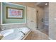 Soaking tub and glass shower in a neutral, decorated bathroom at 1788 River Bluff Vw, Duluth, GA 30097