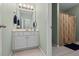 Well-lit bathroom featuring a single sink vanity with a view to the shower at 1788 River Bluff Vw, Duluth, GA 30097