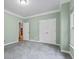 Bedroom with gray carpet, light green walls and white trim, plus a view into the hall at 1788 River Bluff Vw, Duluth, GA 30097