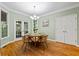 Cozy dining area with hardwood floors, natural lighting, and a stylish chandelier creating a warm ambiance at 1788 River Bluff Vw, Duluth, GA 30097