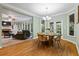 Charming dining space with hardwood floors, elegant lighting, and seamless connection to the living room and outdoor spaces at 1788 River Bluff Vw, Duluth, GA 30097
