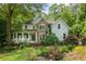 Charming two-story home with a stone and siding exterior, a covered porch and mature landscaping at 1788 River Bluff Vw, Duluth, GA 30097