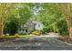 Stately home with stone and siding facade complemented by a long driveway and verdant landscaping at 1788 River Bluff Vw, Duluth, GA 30097