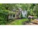 Charming two-story home with stone and siding exterior, complemented by a manicured lawn and mature trees at 1788 River Bluff Vw, Duluth, GA 30097