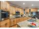 Well-equipped kitchen with wood cabinetry, granite counters, stainless appliances, and breakfast bar seating at 1788 River Bluff Vw, Duluth, GA 30097