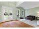 Sunlit living room with French doors, plush seating, and hardwood accents offers a comfortable retreat at 1788 River Bluff Vw, Duluth, GA 30097