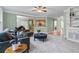 Inviting living room featuring a plush sofa, contemporary decor, and seamless flow into the kitchen and dining area at 1788 River Bluff Vw, Duluth, GA 30097