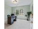 Office room with a large window, dark wooden desk, and neutral colored carpet at 1788 River Bluff Vw, Duluth, GA 30097