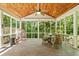 Relaxing screened porch with wood ceiling, comfortable seating, and serene views of the surrounding nature at 1788 River Bluff Vw, Duluth, GA 30097